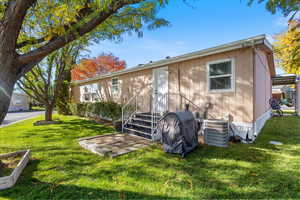 Rear view of house with a lawn