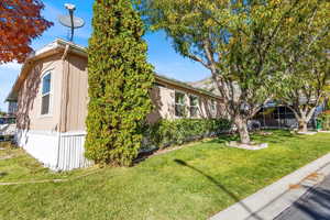 View of home's exterior with a yard