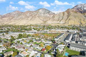 Aerial overview of property's location with nearby suburban area and a mountainous background