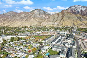 Aerial view of property's location featuring a mountainous background and nearby suburban area