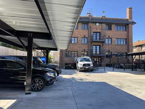 View of building exterior with covered parking