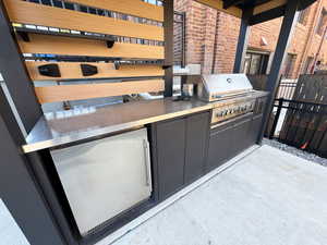 View of patio featuring exterior kitchen