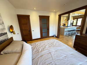 Bedroom with light wood-style flooring, recessed lighting, and two closets