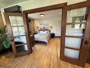 Bedroom with light mahogany wood doors, window, and finishes