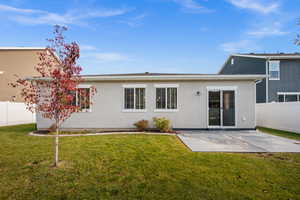 Rear view of property with stucco siding and a patio area