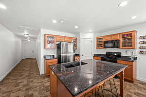 Kitchen with glass insert cabinets and large island with bar.