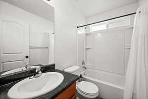 Full Bathroom featuring tub/shower combo and quartz top vanity.
