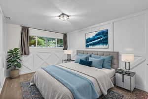 Carpeted bedroom featuring a decorative wall