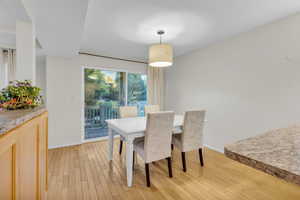 Dining room with light wood-type flooring and baseboards