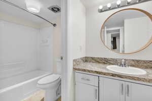Bathroom with vanity and tub / shower combination