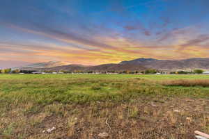 View of mountain backdrop featuring rural landscape