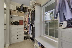 Spacious closet with light colored carpet