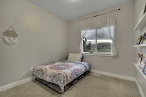 Bedroom with light carpet