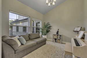 Living area with lofted ceiling and a chandelier