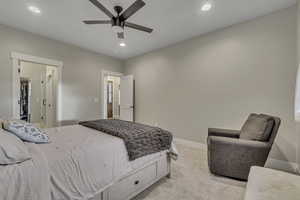 Bedroom featuring light carpet, recessed lighting, ceiling fan, and a spacious closet
