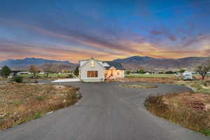View of front facade featuring a mountain view and curved driveway