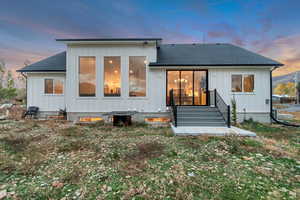 Back of house featuring board and batten siding and a shingled roof