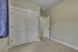 Unfurnished bedroom featuring carpet floors and a closet