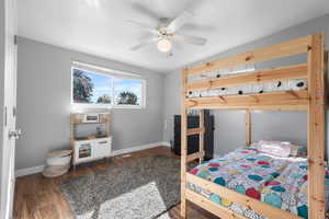 Bedroom featuring wood finished floors and a ceiling fan