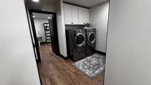 Laundry room featuring light wood finished floors, independent washer and dryer, and cabinet space