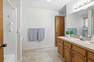 Bathroom with vanity and light tile  floor