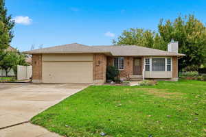 Brick and vinyl rambler home with chimney