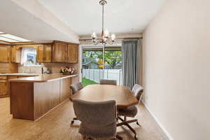 Dining area featuring a chandelier and light wood-style floors