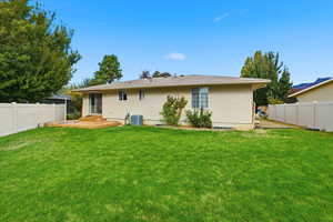 Rear view of house featuring a fenced backyard