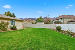 Fenced backyard featuring a mountain view