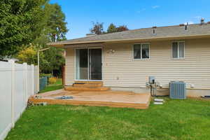 Rear view of house with a deck and a shingled roof