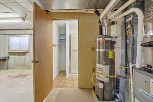 Utility room with strapped water heater and heating unit