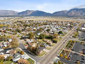 Aerial overview of property's location with nearby suburban area and a mountainous background
