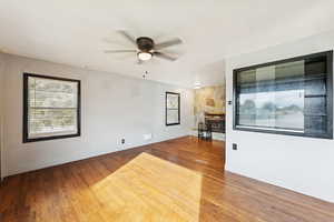 Spare room with wood finished floors and a ceiling fan
