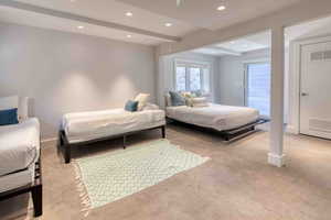 Bedroom featuring light colored carpet, beam ceiling, and recessed lighting