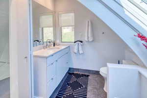 Bathroom featuring vanity and toilet