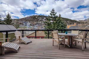 Wooden terrace with a mountain view and outdoor dining area
