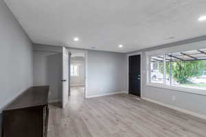 Unfurnished living room with light wood-style flooring and recessed lighting