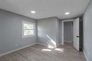 Bedroom 2 featuring light wood-type flooring and recessed lighting