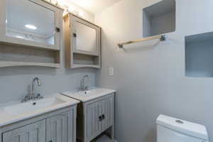 Full master bath with two vanities and toilet