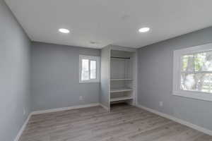 Unfurnished bedroom 2 featuring a closet, light wood-style flooring, and recessed lighting