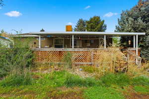 Back of property featuring a chimney