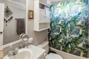 Bathroom with vanity and shower / bath combination with curtain