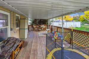 Wooden deck featuring outdoor dining space