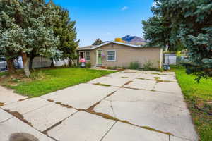 View of front of house featuring a mountain view and driveway
