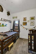Bedroom featuring carpet and crown molding
