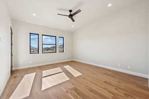 Spare room with light wood-type flooring, ceiling fan, and recessed lighting