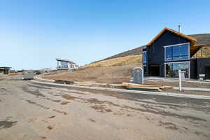 View of asphalt road featuring curbs