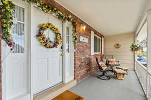 View of exterior entry with covered porch and Lake Views