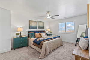 Primary bedroom with ceiling fan and lake views