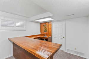 Indoor wet bar featuring wooden counters